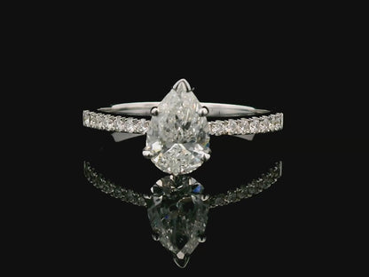 18K Gold Engagement Ring With 1.01 Carat Pear-Shaped Diamond And Accent Diamonds.