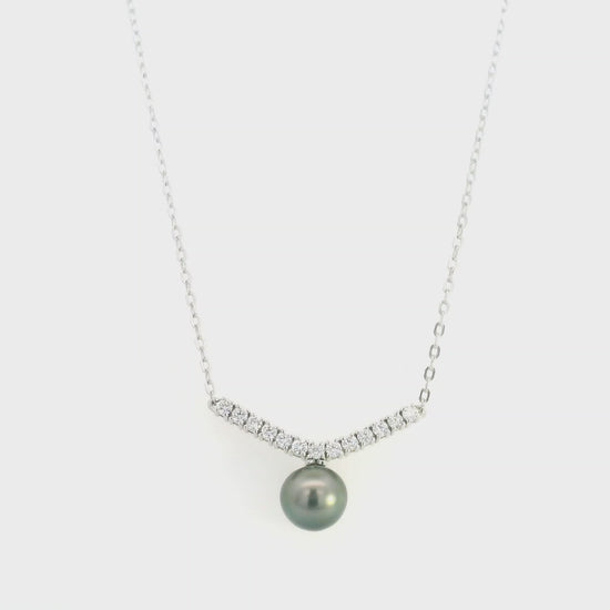 Tahitian black pearl and diamond necklace in 18K white gold featuring a dark grey pearl suspended beneath a gently curved row of round diamonds on a delicate white gold chain.