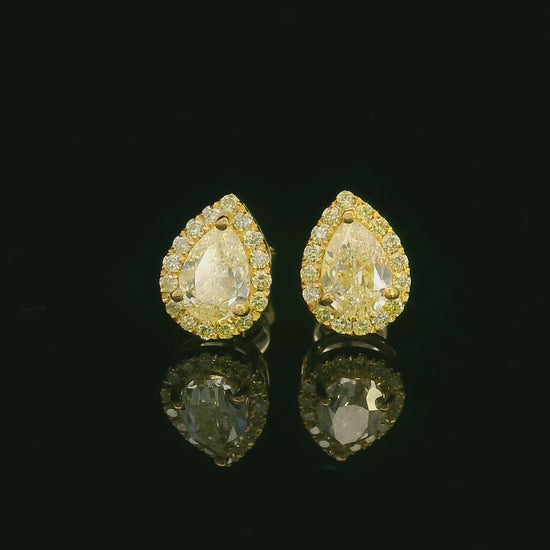 Pear-shaped fancy yellow diamond halo earrings in yellow gold setting