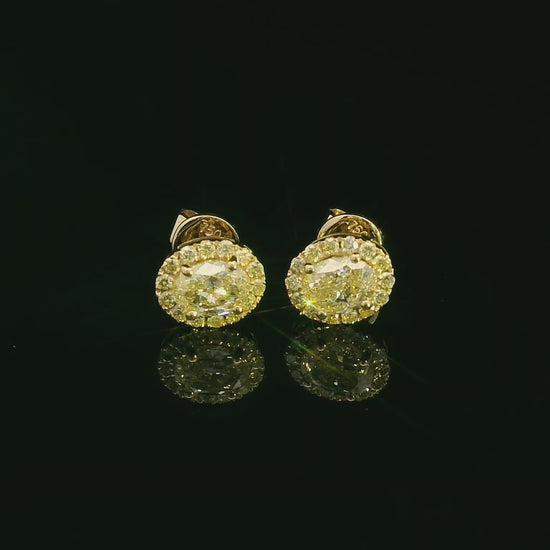 Classic halo diamond earrings in yellow gold featuring vibrant yellow center stones
