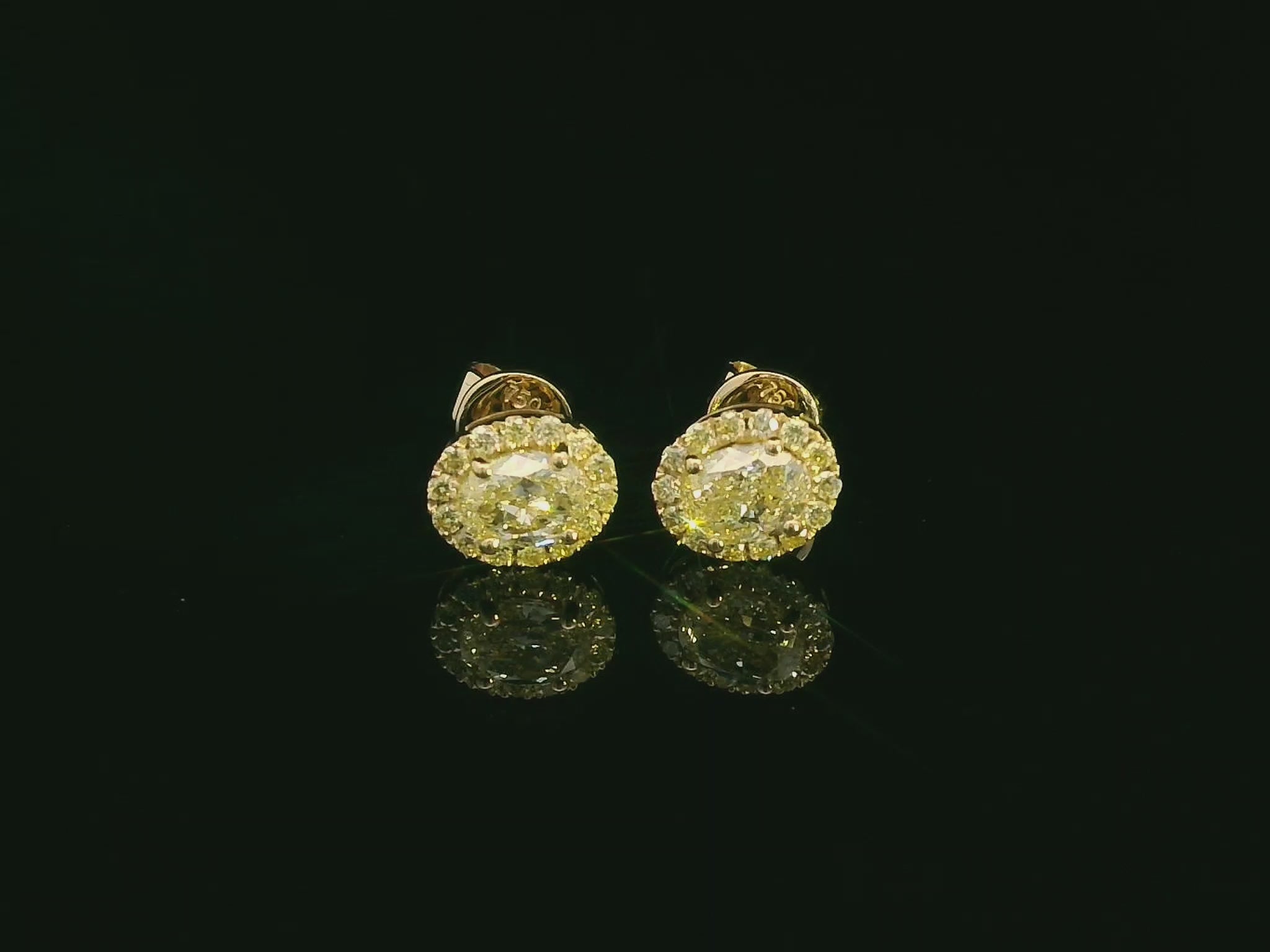 Classic halo diamond earrings in yellow gold featuring vibrant yellow center stones