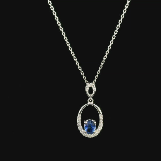 Oval blue sapphire and diamond pendant in 18K white gold with open oval design