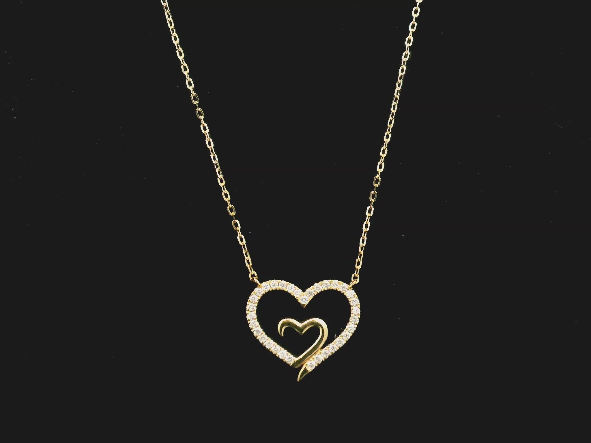 18K yellow gold open heart diamond necklace with pavé diamonds and modern romantic design.