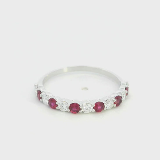Ruby and diamond half eternity ring in 18K white gold with alternating round rubies and diamonds.
