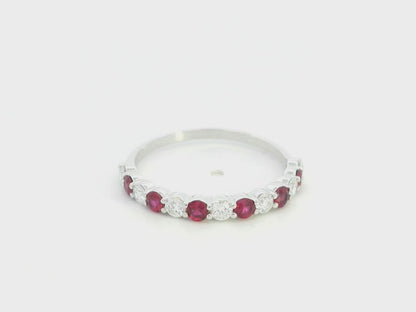 Ruby and diamond half eternity ring in 18K white gold with alternating round rubies and diamonds.