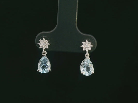 18K white gold aquamarine and diamond drop earrings with blue aquamarine gemstones and round diamond accents