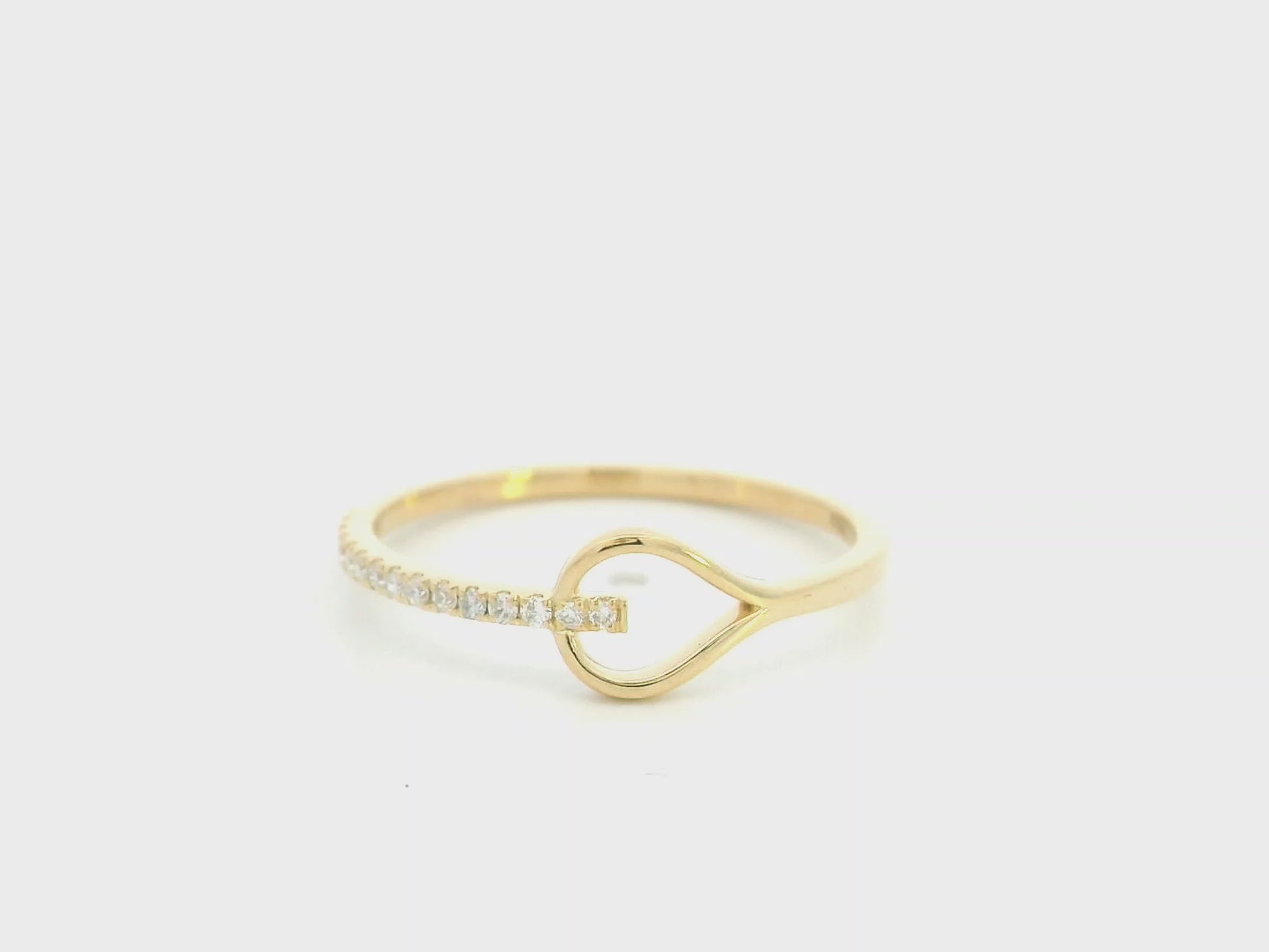 18K yellow gold open teardrop diamond ring with minimalist modern design.