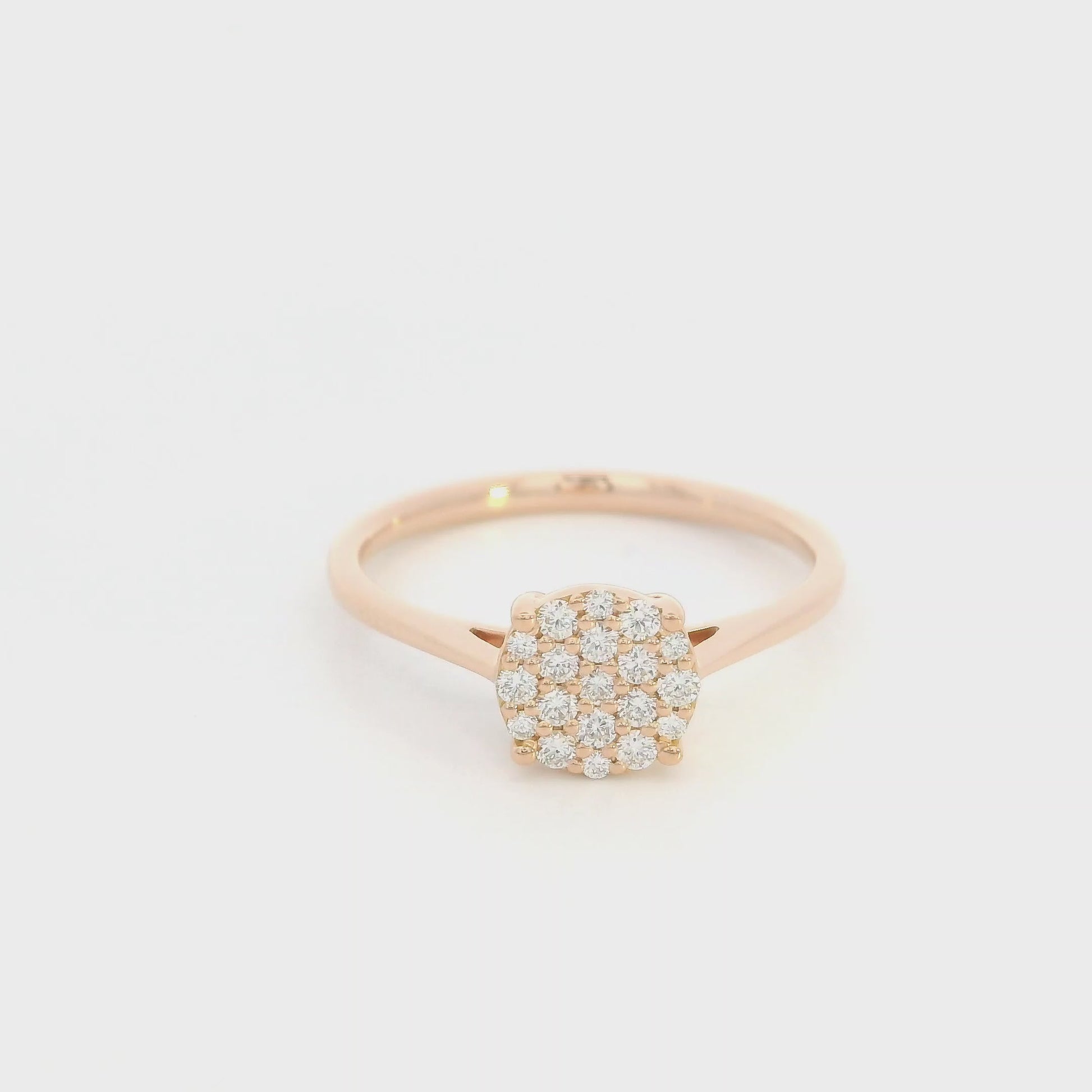 Diamond cluster ring in 18K rose gold featuring round brilliant diamonds arranged across a delicate polished band.