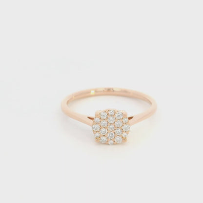 Diamond cluster ring in 18K rose gold featuring round brilliant diamonds arranged across a delicate polished band.