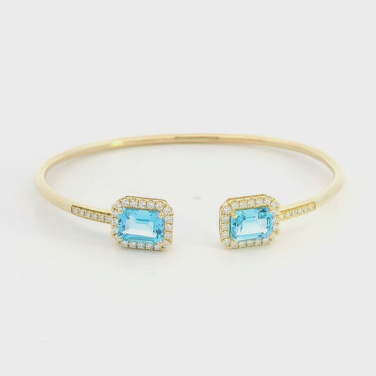 Blue topaz and diamond open cuff bangle bracelet in 18K yellow gold by Emirates Diamonds