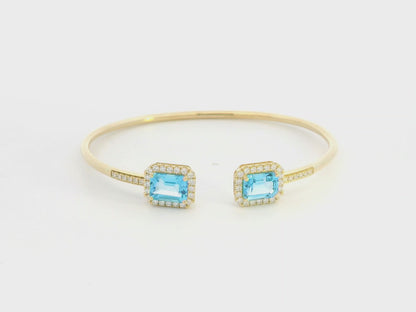 Blue topaz and diamond open cuff bangle bracelet in 18K yellow gold by Emirates Diamonds