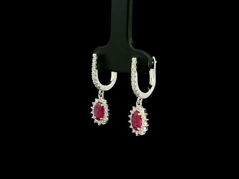 Ruby and diamond drop earrings in 18K white gold with oval ruby centres and diamond halos