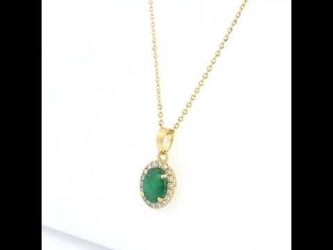 Oval emerald and diamond halo pendant in 18K yellow gold featuring a 1.30 carat green emerald surrounded by round diamonds totalling 0.23 carat. 