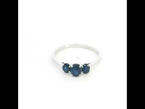 18K white gold ring featuring three oval blue sapphires, with a larger centre gemstone and two smaller side stones on a slim polished band.