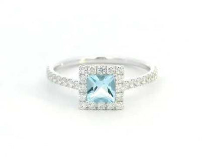 18K White Gold Princess Cut Aquamarine Halo Ring featuring a 0.55 carat natural aquamarine with a diamond halo and pavé diamond band totalling 0.45 carat natural diamonds.