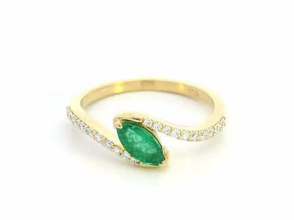 18K yellow gold bypass ring with marquise-cut emerald and round diamond accents