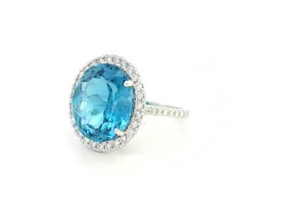 18K white gold ring with 9.15-carat oval London Blue Topaz and double diamond halo – Emirates Diamonds.