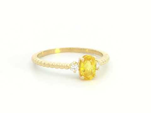 18K gold ring with oval yellow sapphire, side diamonds, and textured beaded band 