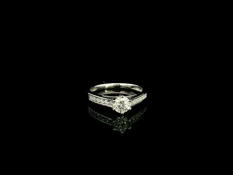 18K white gold engagement ring featuring a 0.60 carat GIA certified natural round brilliant diamond with F color and SI2 clarity, accented by 0.25 carat natural round diamonds on the shoulders in a classic six-prong setting.