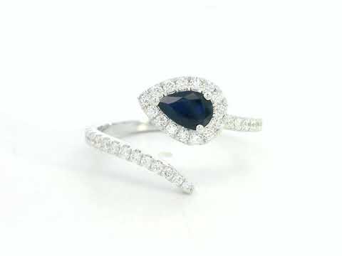 18K white gold bypass ring with pear-shaped blue sapphire and diamond halo by Emirates Diamonds