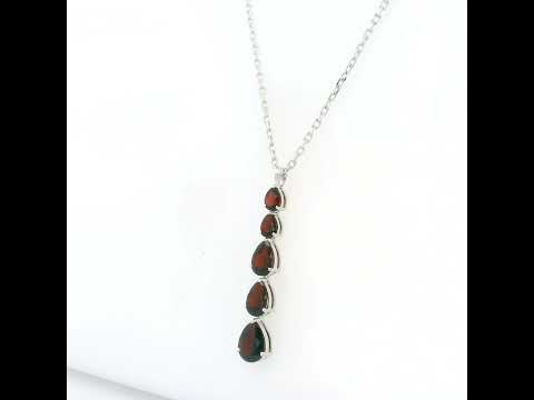 Pear shaped garnet drop pendant in 18K white gold featuring five graduated deep red garnets totalling 2.26 carat, arranged vertically in delicate prong settings. Chain  sold separately 