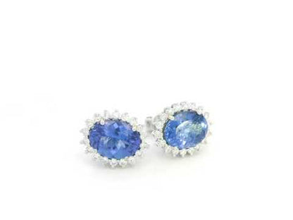18K white gold earrings featuring oval-cut tanzanite gemstones surrounded by diamond halos by Emirates Diamonds.