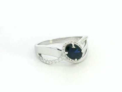 18K white gold blue sapphire and diamond bypass ring with oval sapphire and halo, 0.77 carat sapphire and 0.25 carat total diamond weight, fine jewelry by Emirates Diamonds