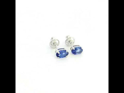 Oval tanzanite solitaire stud earrings in 18K white gold featuring natural blue-violet tanzanites by Emirates Diamonds.