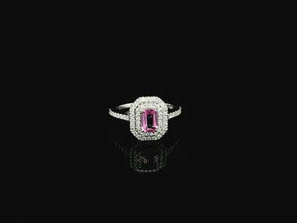18K white gold pink sapphire halo ring featuring a 0.55 carat emerald-cut pink sapphire surrounded by a double halo of natural diamonds totaling 0.40 carat.
