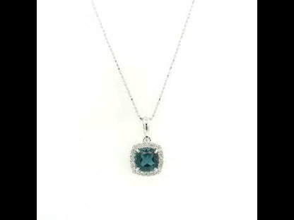 Cushion-cut London Blue Topaz diamond halo pendant in 18K white gold.