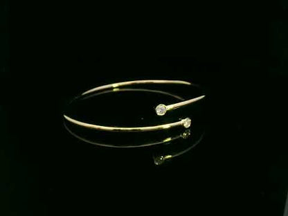 Diamond open cuff bangle bracelet in 18K yellow gold with bezel set diamonds by Emirates Diamonds