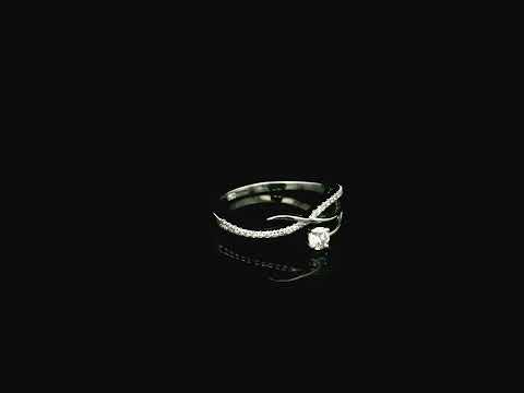 Elegant 18K white gold twist diamond ring featuring a brilliant round centre diamond with flowing pavé diamond crossover band by Emirates Diamonds.