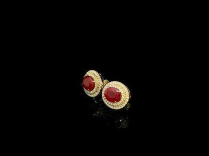 Oval ruby and double diamond halo stud earrings in 18K yellow gold by Emirates Diamonds.