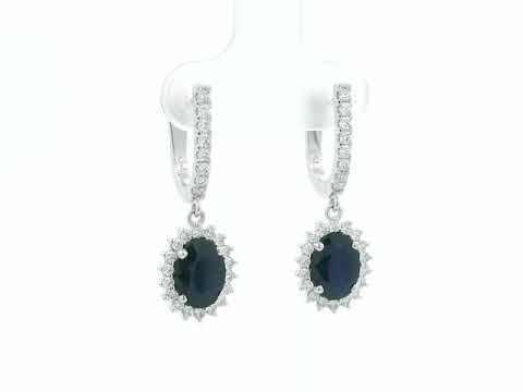 18K white gold sapphire and diamond drop earrings with oval sapphire halos by Emirates Diamonds
