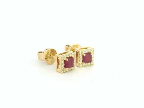 Pair of ruby halo stud earrings with round diamond halos,