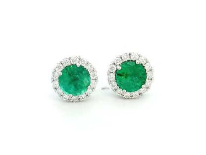 A pair of elegant 18K gold earrings featuring 1.11 carats of round-cut emeralds surrounded by a 0.25-carat halo of sparkling round diamonds, with push-back closures.