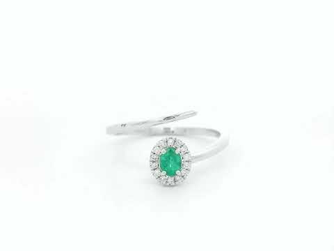 Emerald diamond halo wrap ring in 18K white gold with oval emerald and diamond halo