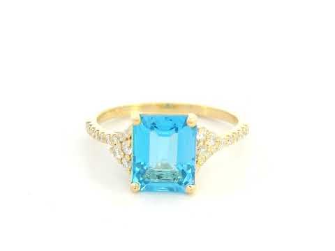 Emerald-cut blue topaz and diamond ring in 18K yellow gold by Emirates Diamonds.