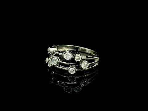 Diamond bezel set multi-row ring in 18K white gold featuring asymmetrically arranged round diamonds across polished open bands.