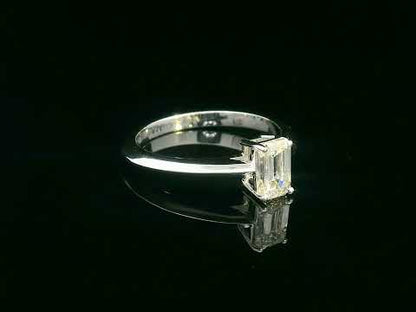 0.91 carat emerald cut diamond solitaire ring with knife-edge 18K gold band, minimalist and elegant design.