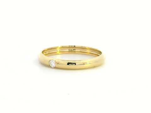 Minimalist 18K gold stackable ring with a 0.05-carat flush-set diamond, perfect as a wedding band, promise ring, or everyday stacking ring.