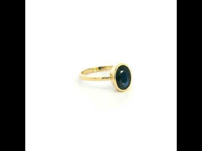 18K yellow gold oval blue sapphire bezel ring featuring a 2.19 Carat natural sapphire in a modern solitaire design.