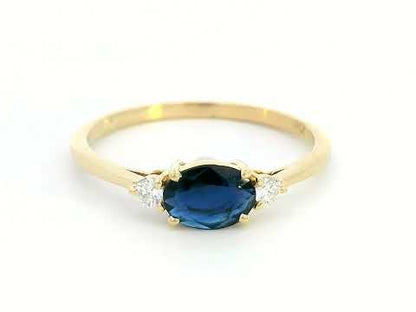 18K gold ring featuring a 0.57 carat oval blue sapphire and 0.09 carat diamonds 