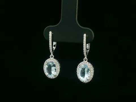 18K gold drop earrings with oval aquamarine center stones and diamond halo design

