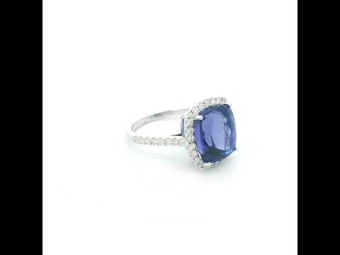 18K white gold cushion cut tanzanite halo ring featuring an 8.95 carat natural tanzanite surrounded by 0.69 carat natural diamonds with diamond-set shoulders.