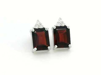 18K white gold garnet and diamond stud earrings featuring emerald-cut garnets (4.11 CT total) with a delicate diamond cluster (0.09 CT total), set in a classic and elegant stud design.