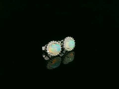 Opal and diamond halo stud earrings in 18K white gold by Emirates Diamonds.