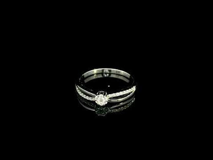 Diamond cluster ring in 18K white gold featuring a floral-inspired round diamond cluster, pavé-set shoulder and polished split-shank design.