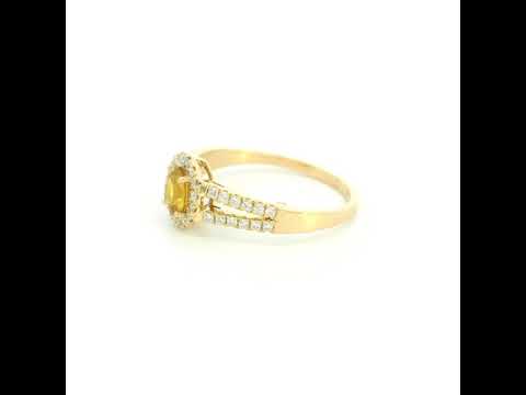 Natural yellow sapphire halo ring in 18K yellow gold featuring a 0.58 carat oval yellow sapphire with a split shank and 0.26 carat natural diamonds.