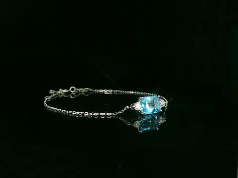18K white gold Swiss blue topaz bracelet with emerald-cut center stone and diamond accents – Emirates Diamonds
